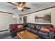 Spacious living room showcasing a large leather sectional, hardwood floors, and neutral walls at 820 Hounds Ridge Ct, Lawrenceville, GA 30043