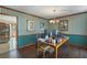 Well-lit office space with striped walls, wood flooring, a pendant light, and functional workspace at 820 Hounds Ridge Ct, Lawrenceville, GA 30043