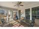 Bright sunroom with ceiling fan, offering comfortable seating and a view of the backyard at 820 Hounds Ridge Ct, Lawrenceville, GA 30043