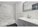 Modern bathroom featuring a marble tiled shower, sleek vanity, and stylish fixtures at 862 Gaston Sw St, Atlanta, GA 30310