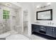 Bright bathroom with walk-in closet, double sink vanity, marble tile, soaking tub, and walk-in shower at 862 Gaston Sw St, Atlanta, GA 30310