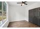 Cozy bedroom with modern ceiling fan, large window, and closet with gray doors at 862 Gaston Sw St, Atlanta, GA 30310