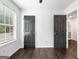 Bedroom features hardwood floors, neutral paint, a window with blinds, and modern doors at 862 Gaston Sw St, Atlanta, GA 30310