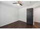 Neutral bedroom features hardwood floors, neutral paint, a ceiling fan, and modern doors at 862 Gaston Sw St, Atlanta, GA 30310