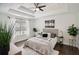 Bright main bedroom with tray ceilings, ceiling fan, and hardwood floors at 862 Gaston Sw St, Atlanta, GA 30310