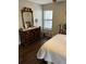 Bedroom with hardwood floors, window and a dark wood dresser with mirror at 2611 Huntingdon Chase, Atlanta, GA 30350