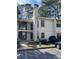 Well-maintained two-story condo featuring neutral stucco exterior and ample parking at 2611 Huntingdon Chase, Atlanta, GA 30350