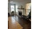 Bright living room featuring a decorative fireplace, hardwood floors, and large windows at 2611 Huntingdon Chase, Atlanta, GA 30350