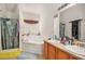 Bathroom featuring a soaking tub, dual sinks, and a walk-in closet at 345 Timberlake Ter, Covington, GA 30016