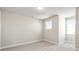 This bedroom features neutral paint, carpet, and two windows which allow natural light at 5604 Meadowstone Walk, Kennesaw, GA 30152