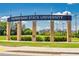 Kennesaw State University entrance with landscaped green space and brick pillars under a clear blue sky at 5604 Meadowstone Walk, Kennesaw, GA 30152