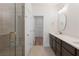 Bathroom featuring double sinks, a glass shower, and an open doorway to a closet at 2219 Nena Way # 22, Tucker, GA 30084