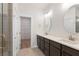 Bathroom featuring double sinks, a glass shower, and an open doorway to a closet at 2219 Nena Way # 22, Tucker, GA 30084