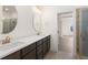 Bathroom featuring double sinks, a glass shower, and a doorway leading to a bedroom at 2219 Nena Way # 22, Tucker, GA 30084