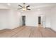 Bedroom with hardwood floors, ceiling fan, and white walls with two open doorways at 2219 Nena Way # 22, Tucker, GA 30084