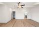 Bedroom with hardwood floors, ceiling fan, and white walls with open doorways to bathroom and closet at 2219 Nena Way # 22, Tucker, GA 30084
