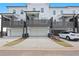 View of white townhomes boasting garages, covered patios, and individual driveways for convenient off-street parking at 2219 Nena Way # 22, Tucker, GA 30084