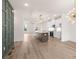 Open-concept kitchen features an island, stainless appliances, quartz countertops, and modern lighting at 2219 Nena Way # 22, Tucker, GA 30084