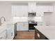 This kitchen has bright white cabinets, stainless steel appliances, and updated fixtures at 2219 Nena Way # 22, Tucker, GA 30084