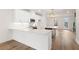 Open kitchen with white cabinets, quartz countertops, and stainless steel appliances, with view to the living area at 2219 Nena Way # 22, Tucker, GA 30084