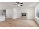 Bright living room space features modern fireplace, neutral paint, and view of the kitchen at 2219 Nena Way # 22, Tucker, GA 30084