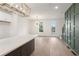 Open living room space with stylish light fixture, luxury vinyl plank flooring, and decorative wall paneling at 2219 Nena Way # 22, Tucker, GA 30084