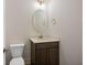 This powder room features a stylish vanity, decorative mirror, and modern lighting at 2219 Nena Way # 22, Tucker, GA 30084