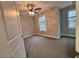 A bedroom featuring neutral walls, carpeted floors, and a lighted ceiling fan at 279 Valley Rd, Lawrenceville, GA 30044