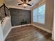 Dining room with a decorative accent wall, hardwood floors, and natural light from large window at 279 Valley Rd, Lawrenceville, GA 30044