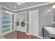 Well-lit bathroom with shower and washer/dryer for ultimate convenience and practicality at 3916 Loch Highland Ne Pass, Roswell, GA 30075