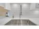 Close-up of a stainless steel sink with a white countertop and subway tile backsplash at 3916 Loch Highland Ne Pass, Roswell, GA 30075