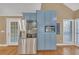 Bright kitchen features stainless steel refrigerator, microwave, and built-in cabinets at 3916 Loch Highland Ne Pass, Roswell, GA 30075