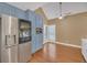 Modern kitchen with stainless steel refrigerator, blue cabinets, and wood floors at 3916 Loch Highland Ne Pass, Roswell, GA 30075
