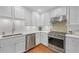 Modern kitchen features white cabinets, stainless steel appliances, and tiled backsplash at 3916 Loch Highland Ne Pass, Roswell, GA 30075