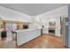 Bright, open kitchen with white cabinets, stainless steel appliances, and a view of the living area at 3916 Loch Highland Ne Pass, Roswell, GA 30075