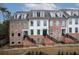 Charming townhomes boast a brick facade, white siding, and striking black accents, inviting curb appeal at 531 Burton Dr, Alpharetta, GA 30009