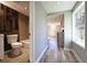 Hallway view featuring a newly remodeled bathroom with wood paneling and a tiled shower at 6886 Upshaw Mill Rd, Douglasville, GA 30134