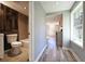 Hallway view showcasing an updated bathroom with modern fixtures and stylish design details with wood accent wall at 6886 Upshaw Mill Rd, Douglasville, GA 30134