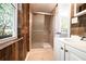 Rustic bathroom featuring a new shower, vanity, and a view to the exterior at 6886 Upshaw Mill Rd, Douglasville, GA 30134