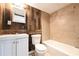 Beautiful bathroom with modern vanity, toilet, and tub/shower combination featuring stylish wood-look and tile accents at 6886 Upshaw Mill Rd, Douglasville, GA 30134