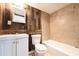 Remodeled bathroom featuring wood paneled walls and new tile, and modern fixtures at 6886 Upshaw Mill Rd, Douglasville, GA 30134