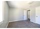 Bright, freshly painted bedroom with plush carpet and adjacent room access at 6886 Upshaw Mill Rd, Douglasville, GA 30134