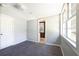 Neutral bedroom with multiple windows that bring in natural light and gray carpet at 6886 Upshaw Mill Rd, Douglasville, GA 30134