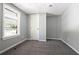 Cozy bedroom with soft gray walls, plush carpet, and a sunlit window at 6886 Upshaw Mill Rd, Douglasville, GA 30134