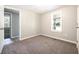 Bedroom featuring fresh paint, new carpet, and a sunny window view at 6886 Upshaw Mill Rd, Douglasville, GA 30134