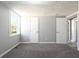 Bright bedroom with new carpet, neutral walls, and multiple doorways, offering a comfortable and versatile space at 6886 Upshaw Mill Rd, Douglasville, GA 30134