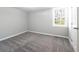 Cozy bedroom features neutral paint, a window providing natural light, and new carpeting for comfort at 6886 Upshaw Mill Rd, Douglasville, GA 30134