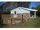 This cozy home features stone accents, a wooden deck, and a covered carport at 6886 Upshaw Mill Rd, Douglasville, GA 30134