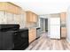 Kitchen area with stainless appliances, updated cabinetry, and wood-look flooring, creating a modern and functional space at 6886 Upshaw Mill Rd, Douglasville, GA 30134