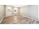 Bright, freshly painted room with new flooring and plenty of natural light from the windows and exterior door at 6886 Upshaw Mill Rd, Douglasville, GA 30134